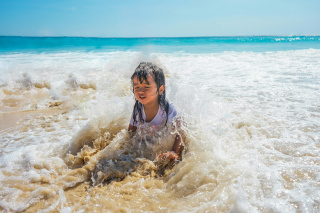 A little girl playing on the beach